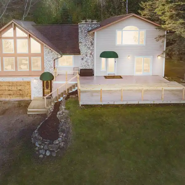 FULLY FURNISHED LAKE CHARLEVOIX HOME WITH DOCK, POLE BARN & STUNNING VIEWS