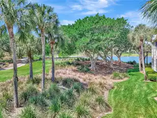 Upper-floor End Unit with Panoramic Golf and Water Views