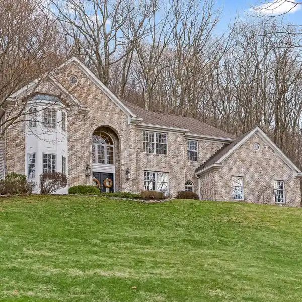 CENTER HALL COLONIAL ON THREE WOODED ACRES