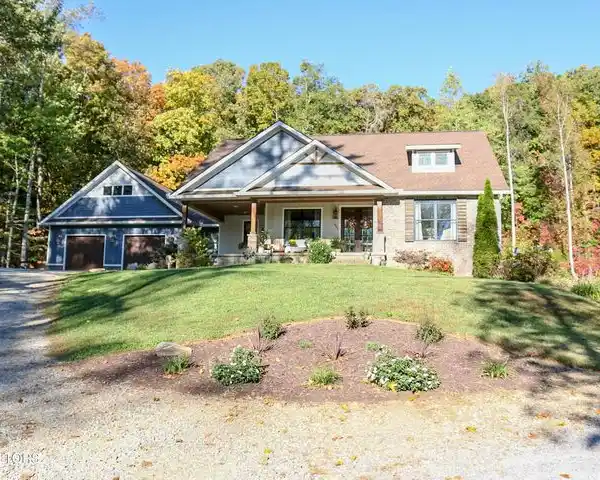 STUNNING CUSTOM HOME ON FIVE PRIVATE WOODED ACRES