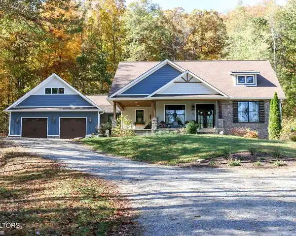 STUNNING CUSTOM HOME ON FIVE PRIVATE WOODED ACRES