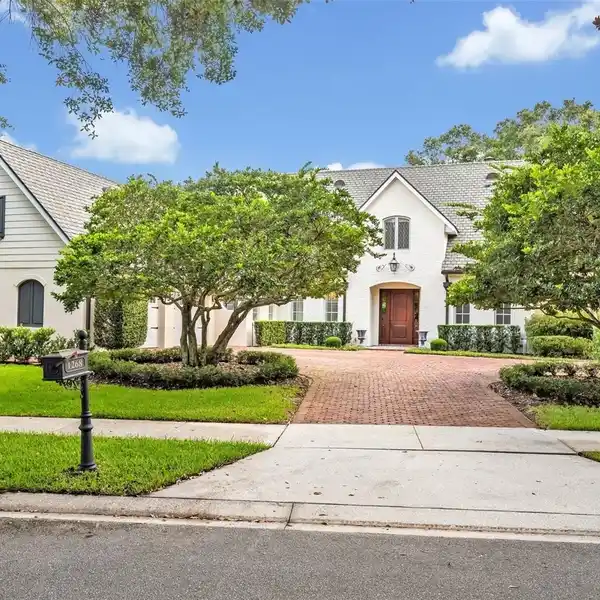 SOARING CEILINGS, BRICK EXTERIOR, AND LUSH LANDSCAPING