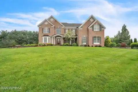 Brick Front Beauty with Dramatic Curved Staircase