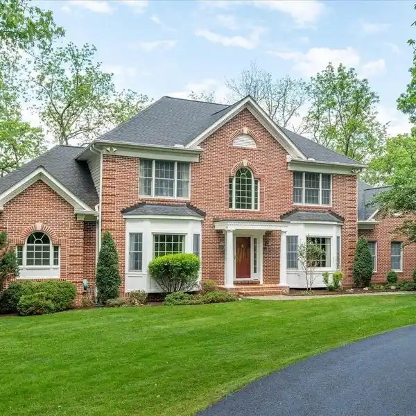 ELEGANT BRICK COLONIAL WITH WOODED SERENITY