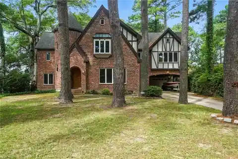 Tudor-Style Waterfront Home with Endless Potential