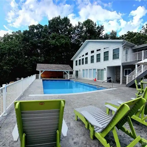 GATED LAKEFRONT RETREAT WITH ENTERTAINER’S DREAM