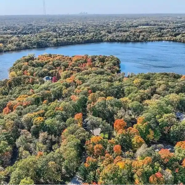 CUSTOM HOME ON A PRIVATE WOODED LOT ON THE ISLAND OF PLEASANT LAKE